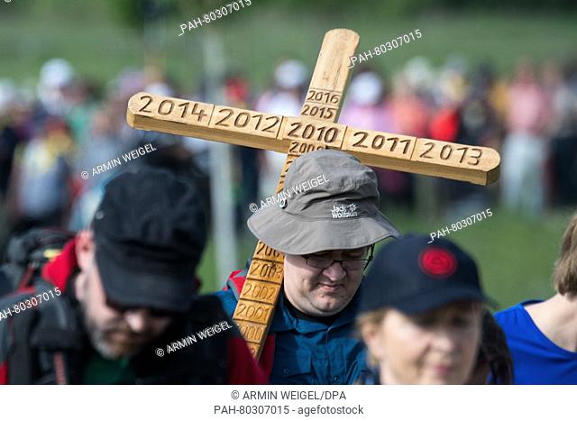 A pilgrim carries a wooden cross during Germany's largest pilgrimage walk in Regensburg, Germany, 12 May 2016. The pilgrimage will see believers make their way...
