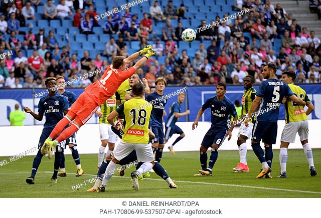Hamburg goalkeeper Christian Mathenia (L) rejects a shot by Barcelona's Javi Fuego during the Hamburger SV vs Espanyol Barcelona test match in the Volkspark...