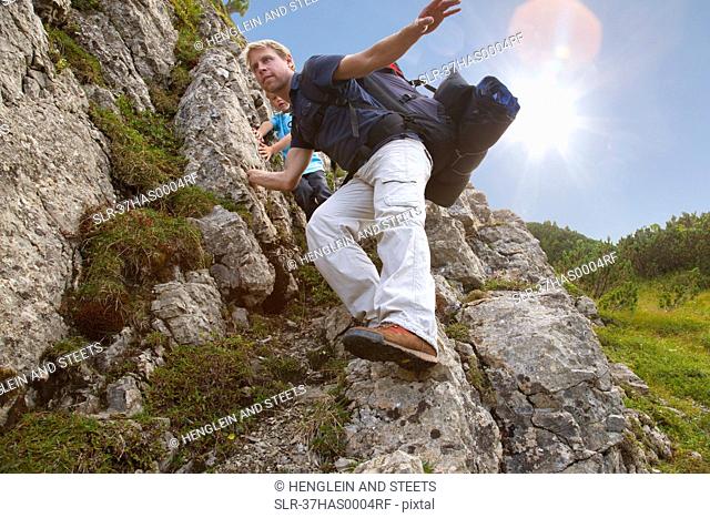 Father and son hiking on rocky terrain