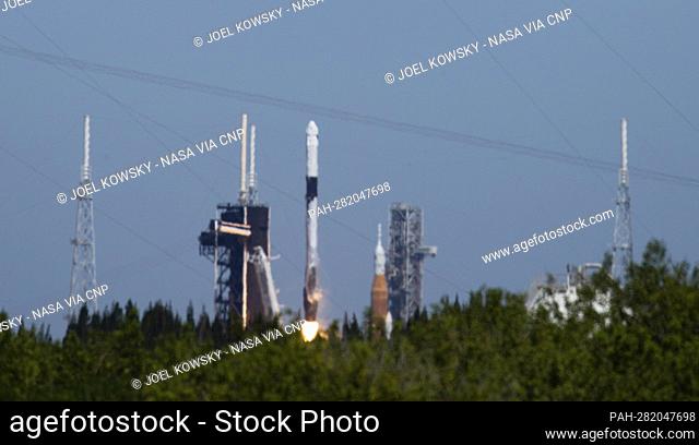 NASA’s Space Launch System (SLS) rocket with the Orion spacecraft aboard is seen atop a mobile launcher at Launch Complex 39B, right