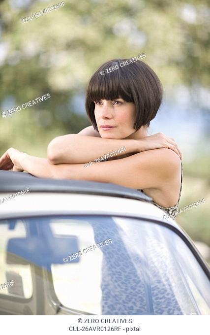 Woman leaning on a car
