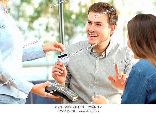 Couple ready to pay consumption with a credit card in a restaurant