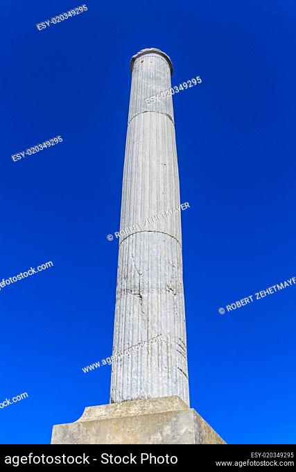 Column on blue sky background