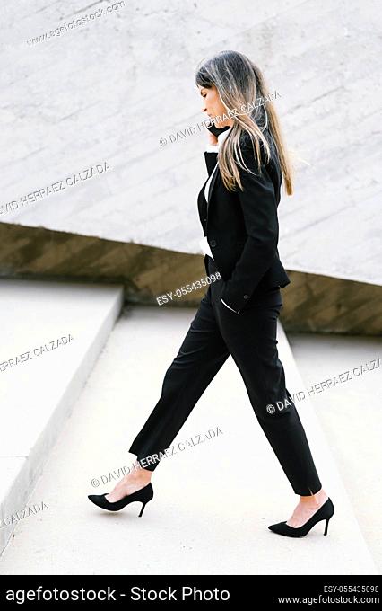Business woman wearing heels climbing the Stairs in the city. High quality photo