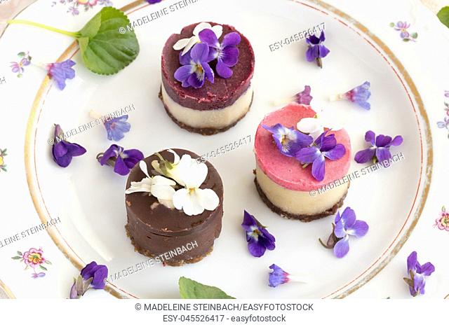 Raw vegan desserts with fresh violet and lungwort flowers