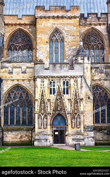 The view of the north side of the Exeter Cathedral (Cathedral Church of Saint Peter) with the Gothic entrance covered by the carved statues of the saints