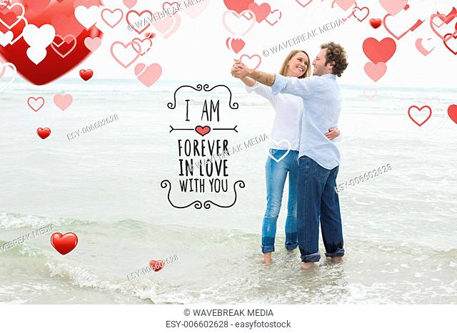 Composite image of full length of a couple dancing at beach