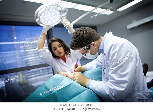 Reportage in a dermatology practice in Geneva, Switzerland. The dermatologist removes a suspicious mole, helped by his assistant