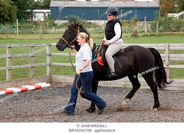 Woman with visual impairment having riding lesson