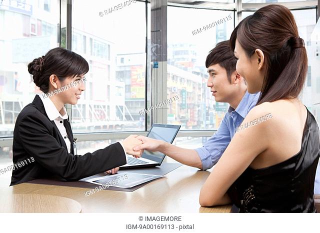 Business person looking away with smile and handshake