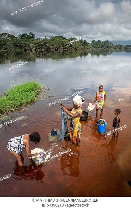 Women washing clothes in the river Ntem, in the rainforest, Campo, Southern Region, Cameroon
