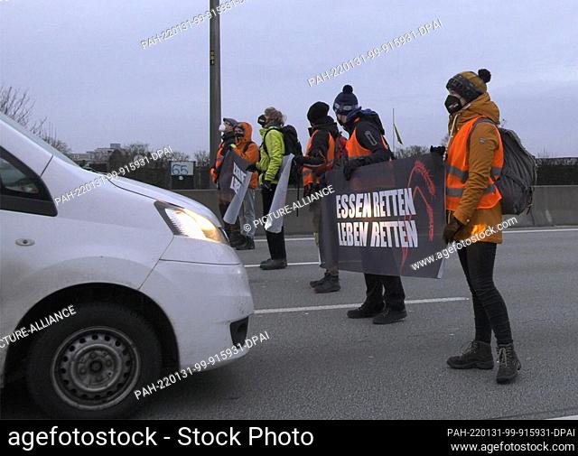 31 January 2022, Berlin: Activists of the group ""Uprising of the Last Generation"" block the city highway 100 (A100) not far from Beusselstraße