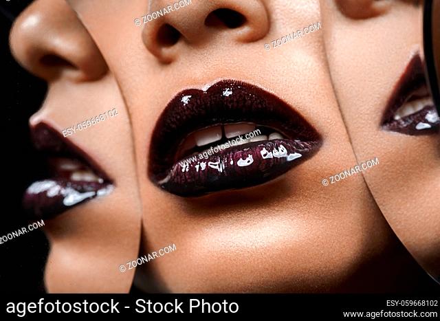 closeup shot of full sexy woman lips with black lipstick with mirror reflections. copyspace
