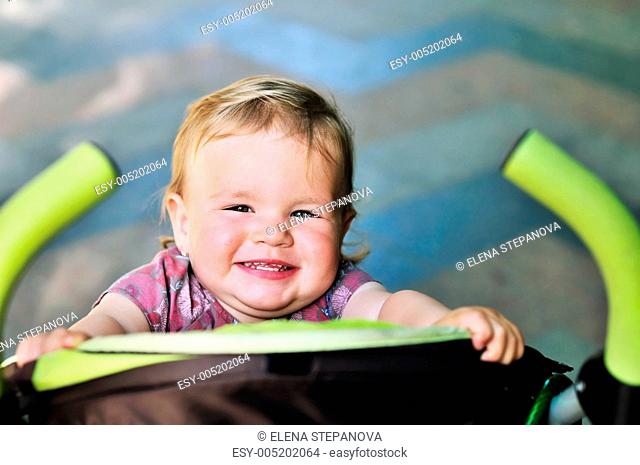 baby girl having fun in the stroller
