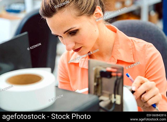 Close-up of Woman working on label printing machine