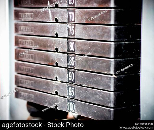 Stack of rusty metal weights in gym bodybuilding equipment. Bodybuilding concept. Hign contrast and monochrome color tone