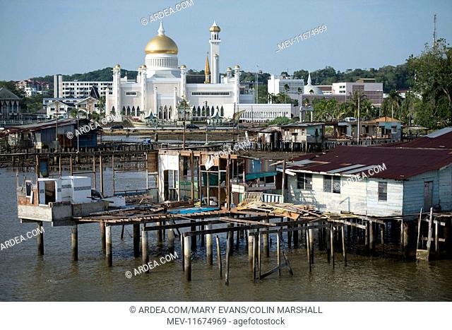 Mosque by river Opulent Sultan Omar Ali Saifuddien Mosque on Kedayan River, with shacks in foreground