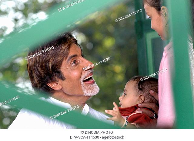 South Asian Indian Bollywood actor Amitabh Bachchan with a child promoting polio drops NO MR
