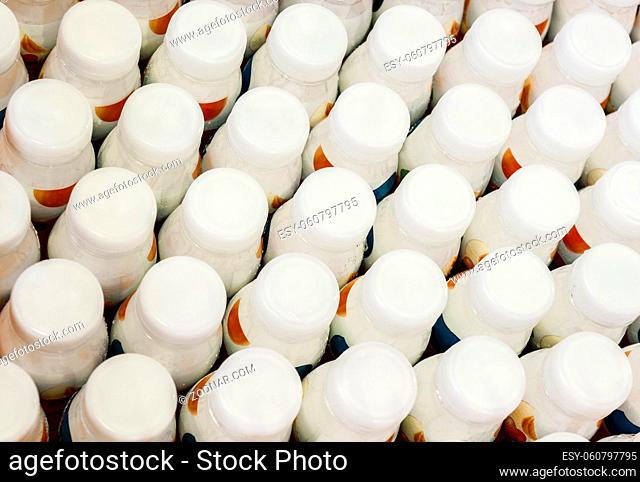 top view of a group of white plastic bottles with dairy products
