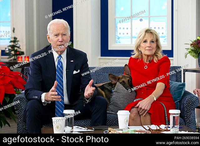 United States President Joe Biden, left, and first lady Dr. Jill Biden, right, sit with their dog, a German Shepherd puppy named 'Commander’, ’ center