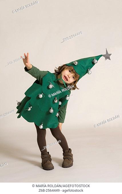 Christmas; 3 years old little girl dressed up as a Christmas tree,