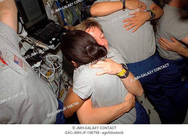 Astronauts Stephanie Wilson (right), STS-120 mission specialist, and Peggy Whitson, Expedition 16 commander, exchange hugs during a farewell ceremony in the...