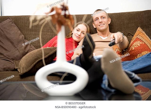 couple watching TV on a couch