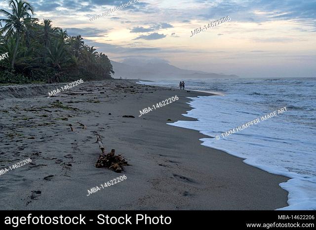 South America, Colombia, Departamento del Magdalena, Santa Marta, Guachaca, walker on the beach in front of Costäo Beach Hostel