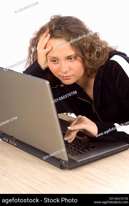 isolated on white bored/tired female teenager at the laptop