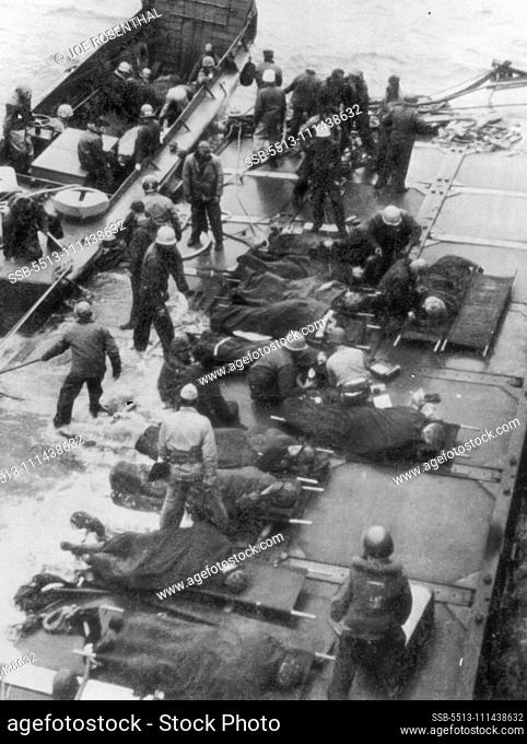 Wounded Marines Moved From Iwo Jima from the Japanese, are placed on a pontoon barge for transfer to other craft for immediate removal from the danger zone