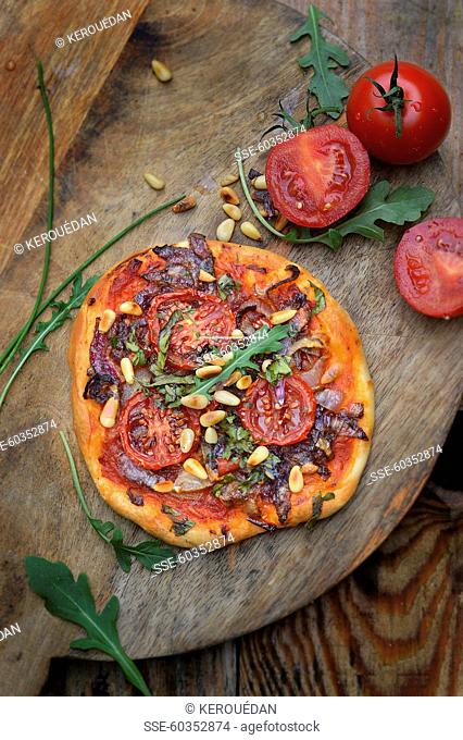 Tomato, red onion and pine nut pizza