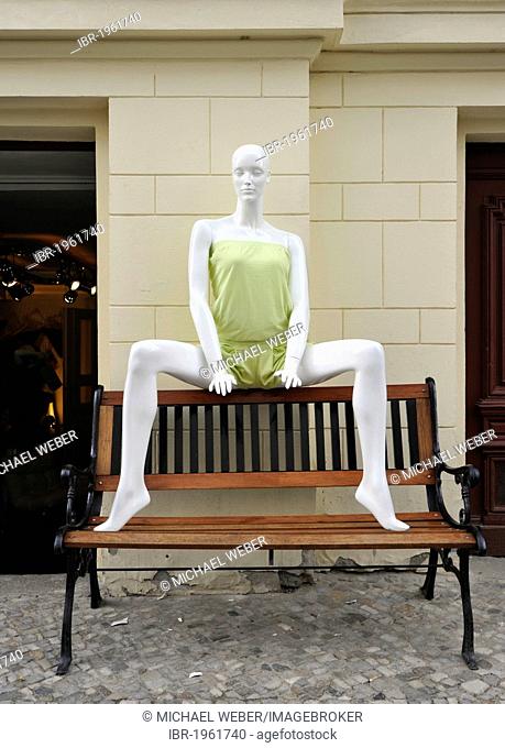Mannequin sitting with her legs spread provocatively on an outdoor bench, Berlin, Germany, Europe, PublicGround