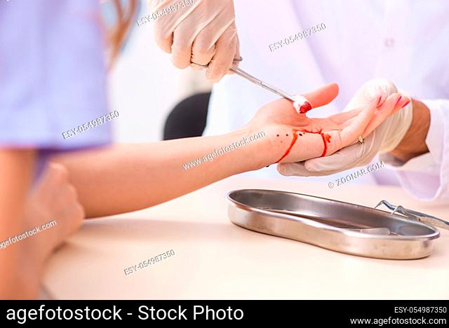 Hand injured woman visiting male doctor
