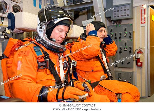 Astronauts Tim Kopra (left) and Dave Wolf, both STS-127 mission specialists, attired in training versions of their shuttle launch and entry suits