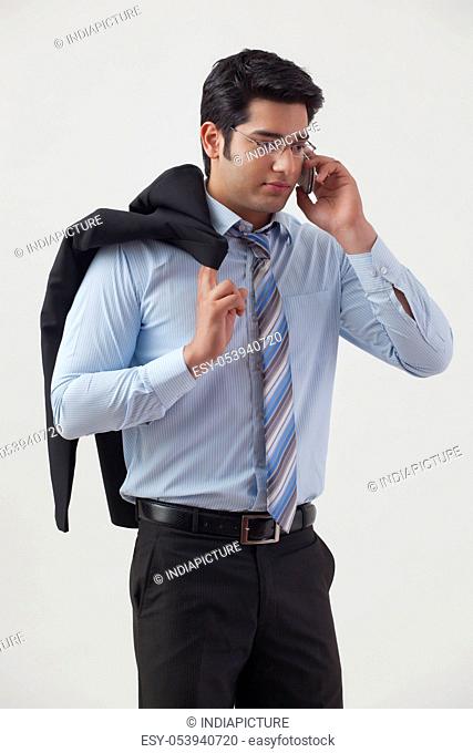 Handsome young businessman talking on cell phone