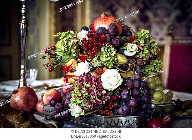 Composition of fruit and flowers on a laid table, court life in the Stupinigi hunting lodge, Italy, 18th century. Historical re-enactment