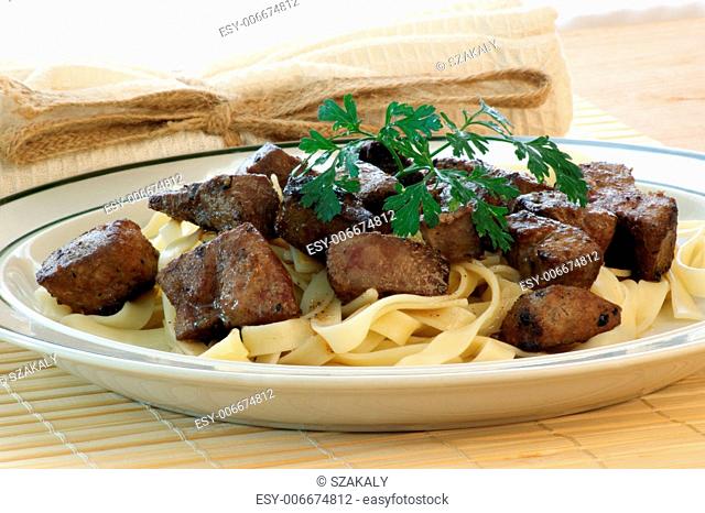 liver goulash on pasta with organic parsley