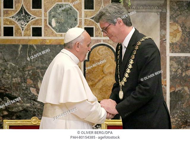 RE-CROP. Pope Francis (l), shakes hands with the the Lord Mayor of Aachen, Marcel Philipp (CDU) during the ceremony for the award of the International...
