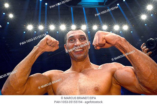 The old and new IBF, WBO, WBA and IBO heavyweight boxing world champion, Wladimir Klitschko (R), celebrates after his victory obver his Polish challenger Wach...