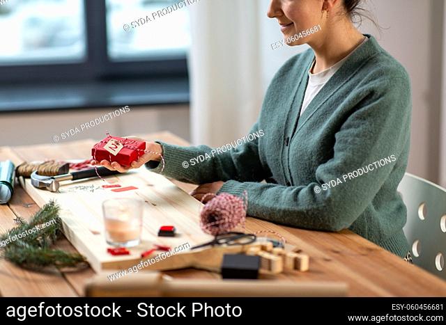 close up of woman holding christmas gift at home