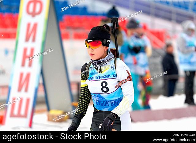 Korean sportswoman biathlete Lee Hyunju South Korea at finish line after skiing, rifle shooting during Regional junior biathlon competitions East of Cup