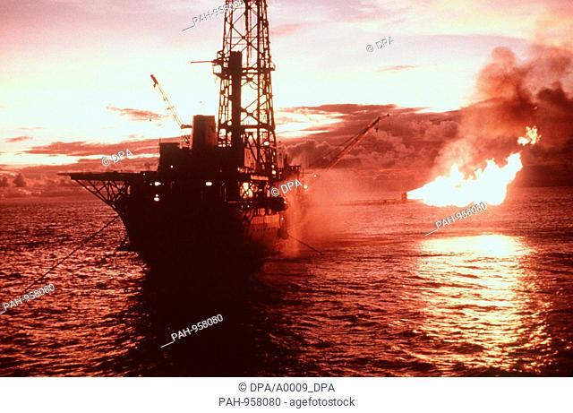 An Australian drillship looking for natural gas and petroleum deposits. In the background exhaust flares. (undated image) | usage worldwide
