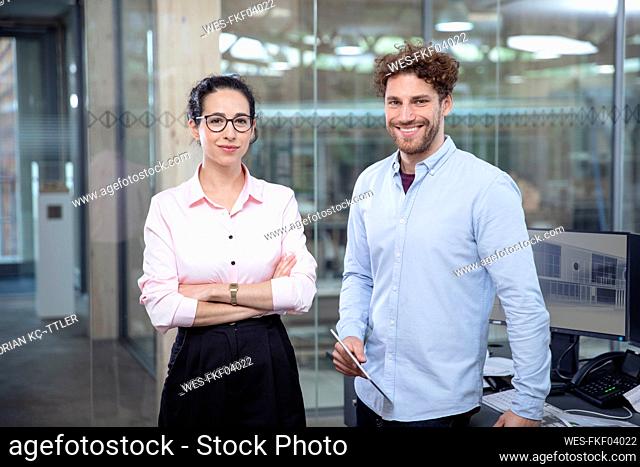 Male and female entrepreneurs standing in office