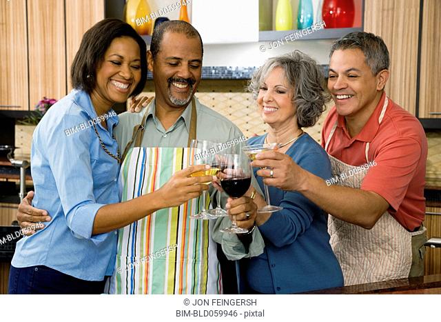 Multi-ethnic friends toasting with wine