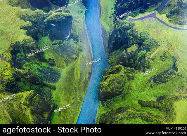 aerial view of famous and unique fjadrargljufur valley in iceland on a rainy day in iceland. mossy cliffs and mountain river