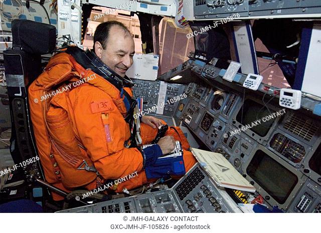 While seated at the commander's station, astronaut Mark L. Polansky, STS-116 commander, participates in a training session in the crew compartment trainer...