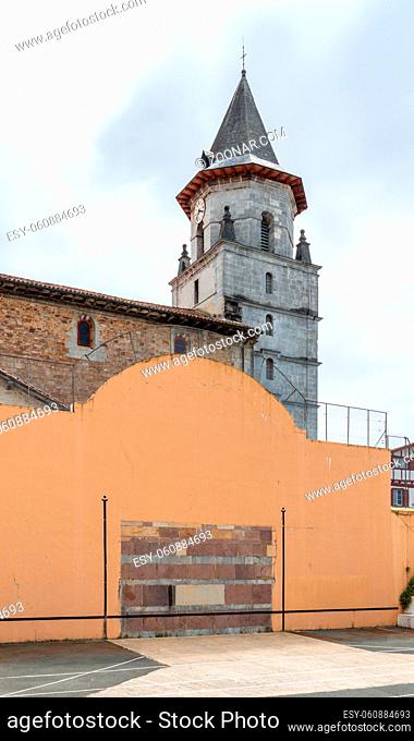 Basque pelota wall and court in Ainhoa, France. Church in the background
