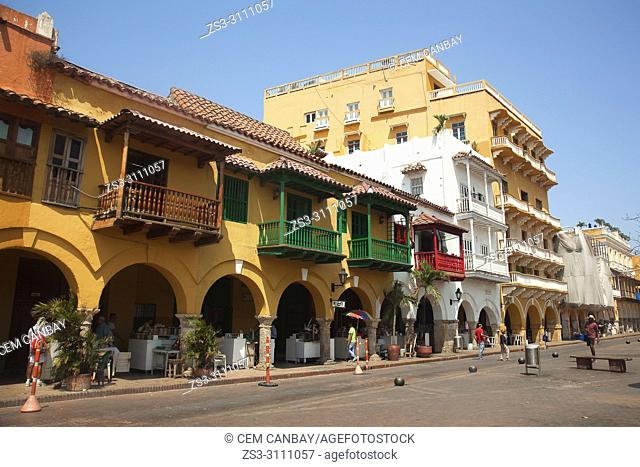 View to the colorful colonial buildings and balconies at the historic center in Plaza de Los Coches Square, Cartagena de Indias, Bolivar, Colombia