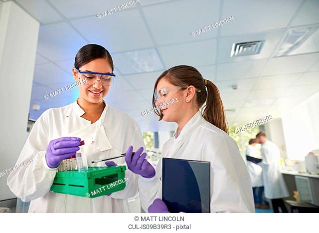 Scientists in laboratory discussing samples