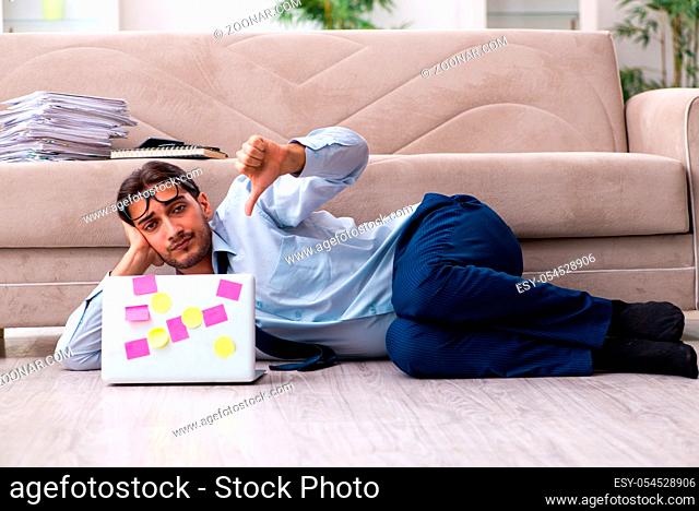 The young male businessman working at home